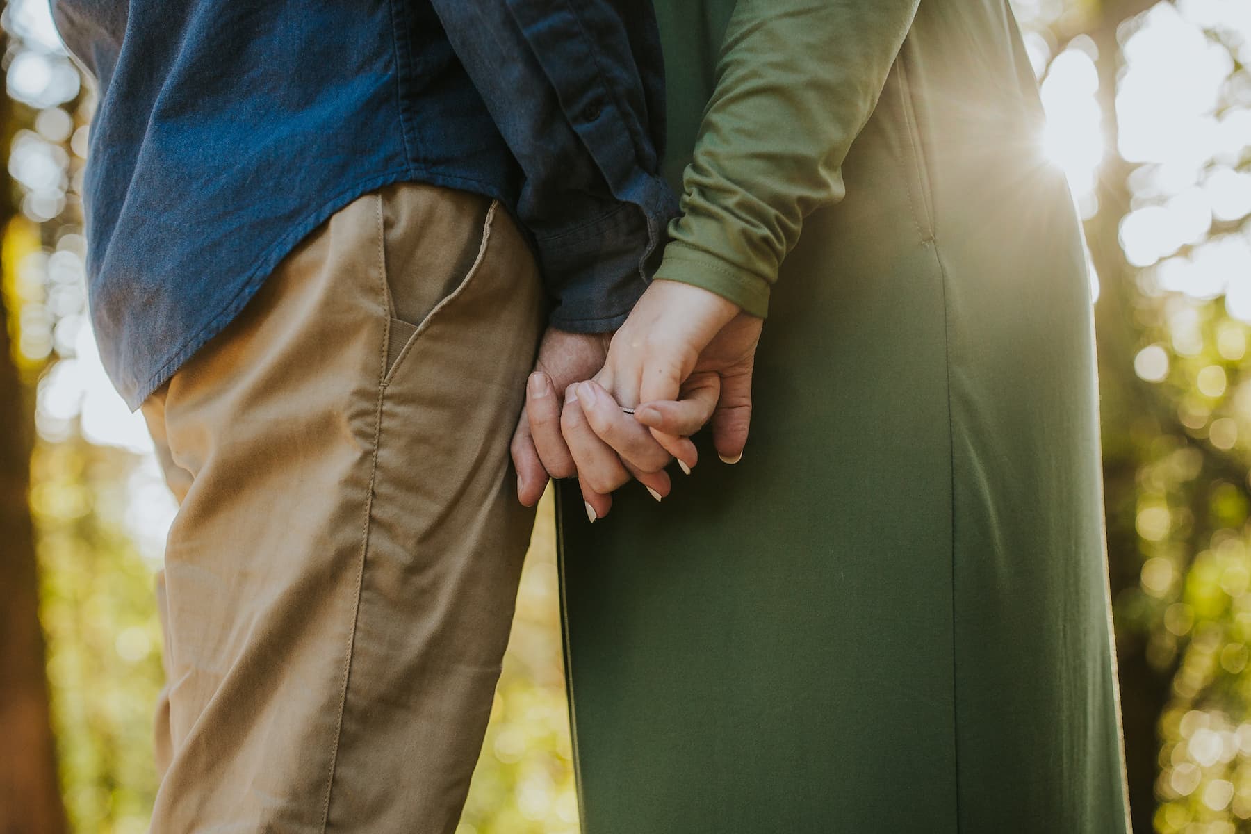 A close-up image of Glen and Heather holding hands